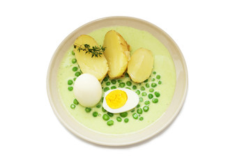 White and yellow egg with peas sauce and potato