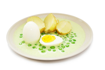 White and yellow egg with peas sauce and potatoe