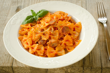 Farfalle topped with tomato sauce and meat