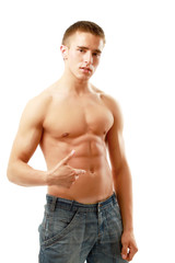 Fototapeta premium A muscular man showing his abs, isolated on white background