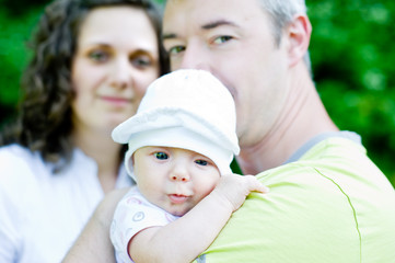 mom, father and a baby - obrazy, fototapety, plakaty