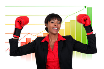 Businesswoman wearing boxing gloves