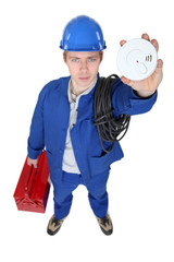 portrait of young electrician holding alarm