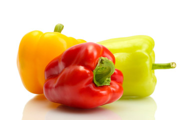 fresh yellow, red and green bell peppers isolated on white