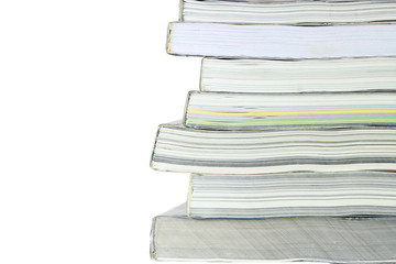 Stack of books on white background, partial view.