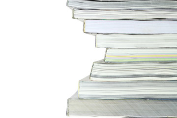 Stack of books on white background, partial view.