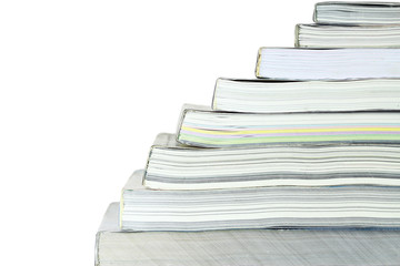 Stack of books on white background, partial view.