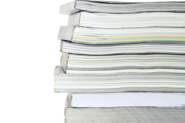 Stack of books on white background, partial view.