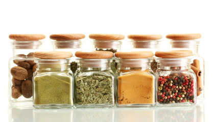 powder spices in glass jars  isolated on white