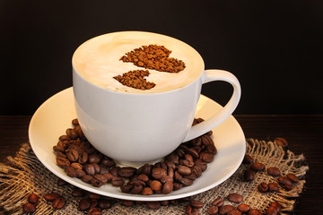 Latte on wooden table on brown background
