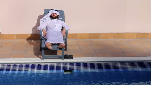 Saudi arabian man enjoying at swimming pool