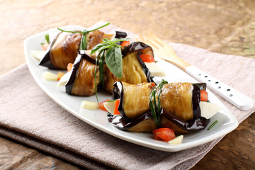 Eggplant rolls with cheese, tomato and basil