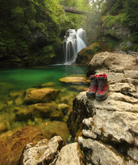 Hiking boots and beautiful waterfall (photo taken in Slovenia)