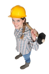 Female manual worker holding a sledge hammer