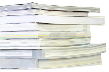 Stack of books on white background, partial view.