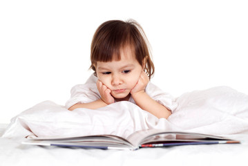 Pretty Caucasian little girl with a book