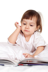 Pretty Caucasian young baby with a book