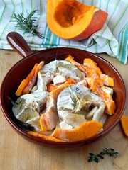 Fresh fish with spices and pumpkin in cream