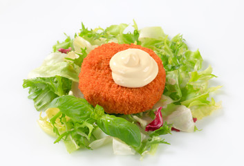 Fried cheese with green salad and mayonnaise