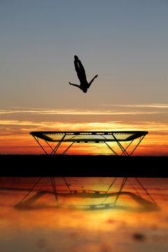 silhouette of trampoline gymnast on beach Stock Photo | Adobe Stock