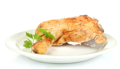 roasted chicken leg with parsley in the plate isolated on white