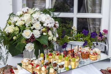 Flowers bouquet and tray canapes