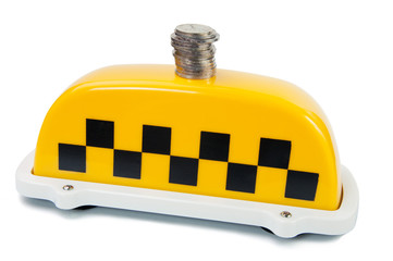 Taxi fare: coins on a yellow taxi sign, white background