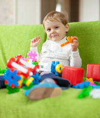 child plays with toys in home