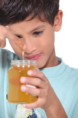 Young boy tasting some honey