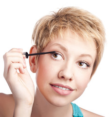 Fototapeta premium Young woman paints the eyelashes