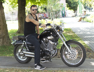 Fototapeta na wymiar Rebel young man on a motorcycle