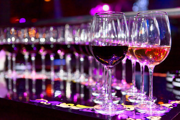 Glasses of red and white wine at the table