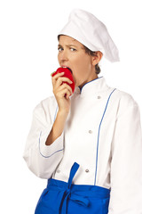 Beautiful Woman chef eating red hot chili pepper