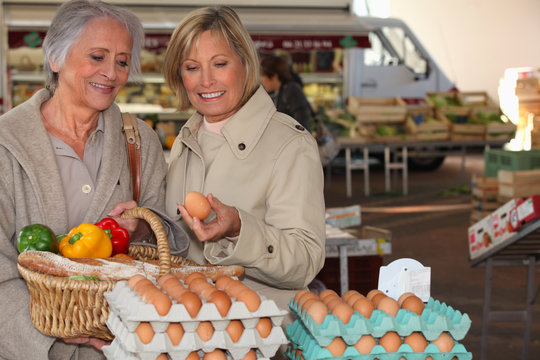 Two Senior Women Shopping On The Market