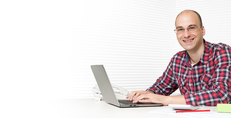 young business man using a laptop at the desk