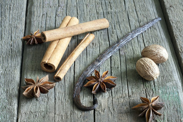 Exotic spices vanilla, nutmeg, star anise on boards