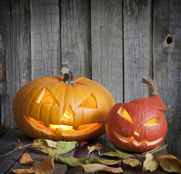Halloween pumpkins on old grunge boards with leaves background