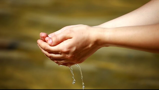 Woman's hands with water splash