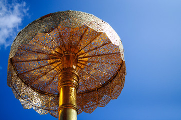 Golden Tiered Umbrella in clear sky
