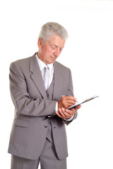 Writing elderly man in suit