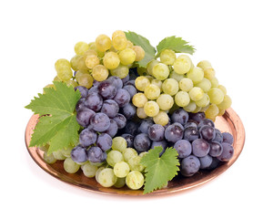Black and white grapes in a  metal bowl isolated ,drops