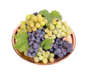 Black and white grapes in a  metal bowl isolated ,drops