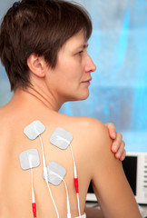 electrodes of tens device on the woman's back, tens therapy, ner