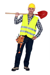 Labourer carrying a spade