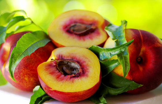 Sliced peachs on green background