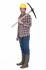 Labourer carrying a pickaxe