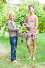 Boy and Girl Holding Basket of Vegetables