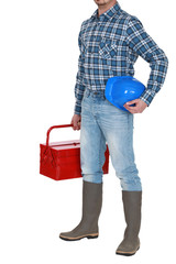 craftsman standing with toolbox and safety helmet