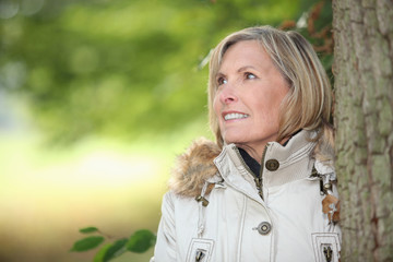 Woman behind tree