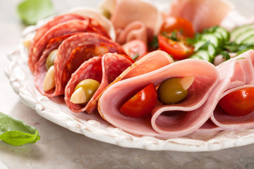 Plate of assorted cold cuts with garlic stuffed olives